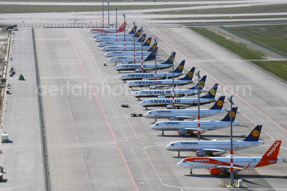Aerial photograph Schönefeld - Decommissioned due to crisis passenger airplanes of the airline Lufthansa in parking position - parking area at the airport in Schoenefeld in the state Brandenburg, Germany