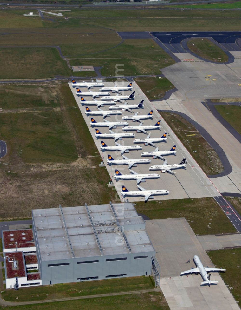 Schönefeld from the bird's eye view: Decommissioned due to crisis passenger airplanes of the airline Lufthansa in parking position - parking area at the airport in Schoenefeld in the state Brandenburg, Germany