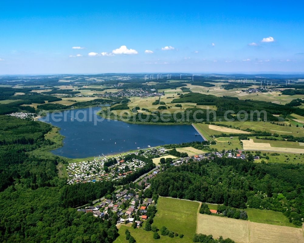 Rehe from the bird's eye view: Krombach barrage fixe and artificial lake in Rehe in the state of Rhineland-Palatinate. The dam and the camping site on the Eastern shore are located in the state of Hesse. The barrage in the Wester Forest region was built 1946-1949 and blocks the Rehbach creek. The lake is also used for recreational activities and parts of it are part of a nature preserve area