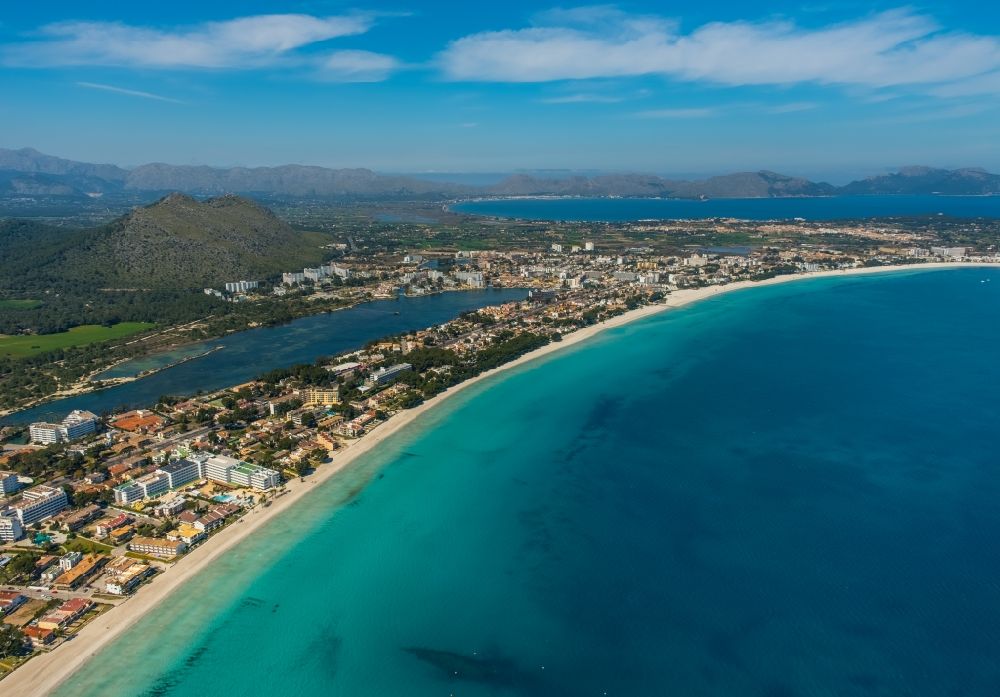 Aerial image Port d'Alcúdia - Coastline on the sandy beach in the Bucht von Alcudia in Port d'Alcudia in Balearic island of Mallorca, Spain