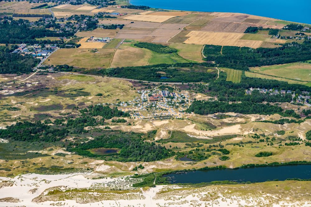 Aerial image Wittdün auf Amrum - Coastline with lighthouse and camp site on the sandy beach of Nordsee- Insel Amrum in Nebel in the state Schleswig-Holstein