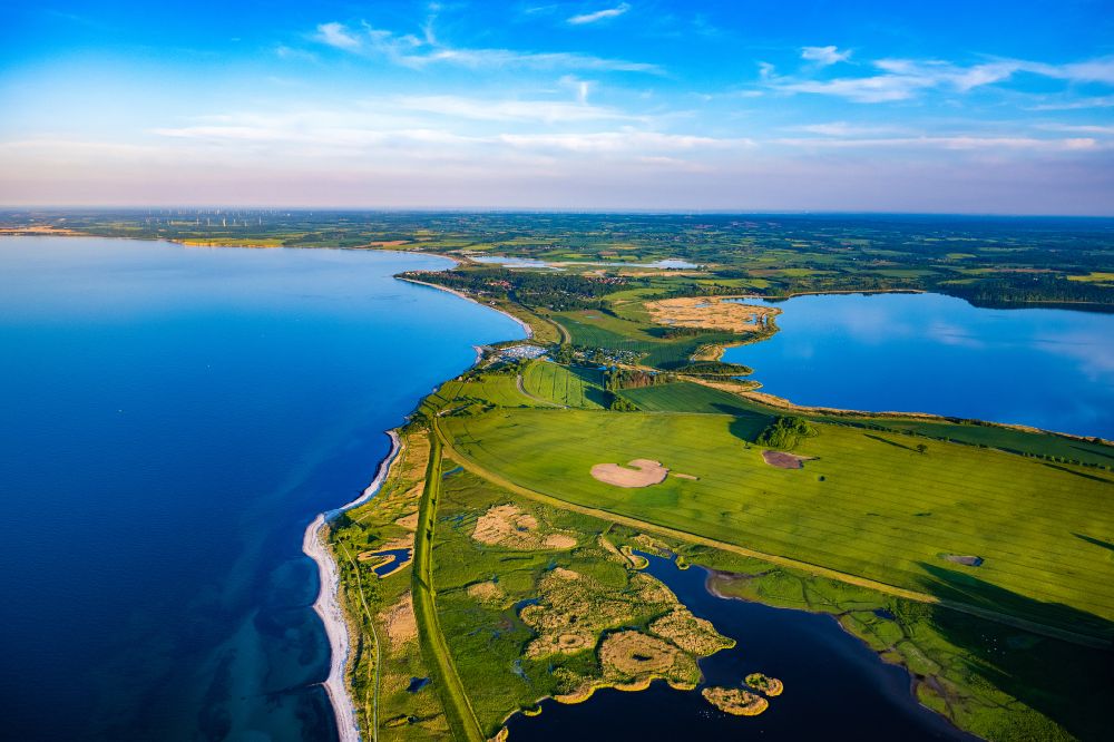 Aerial image Behrensdorf - Coastal landscape on the sandy beach of the Baltic Sea with adjacent salt marshes and large inland lake in Behrensdorf in the state Schleswig-Holstein, Germany