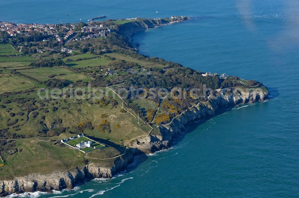 Anvil Point Lighthouse from the bird's eye view: Coastline on Durlston Country Park and National Nature Reserve on Lighthouse Rd at the rocky cliffs of of English Channel Anvil Point Lighthouse in Swanage in England, United Kingdom