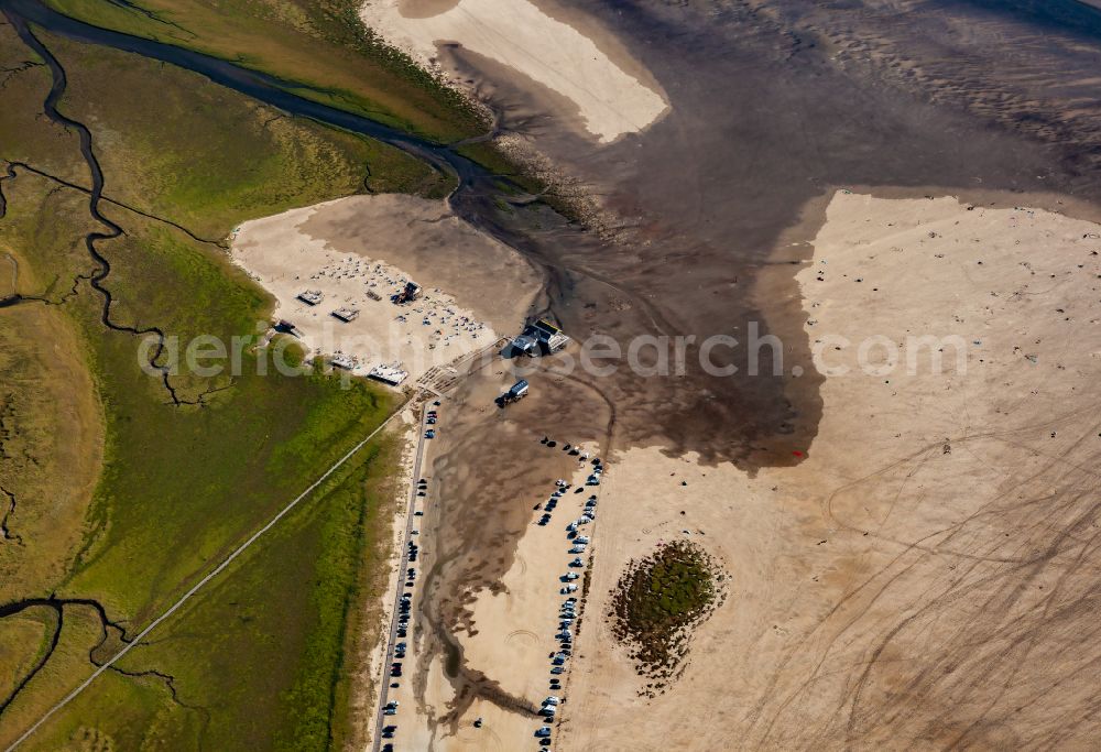 Aerial photograph Sankt Peter-Ording - Coastal landscape and beach parking lot at spring tide on the sandy beach in the district Boehl in Sankt Peter-Ording in the state Schleswig-Holstein, Germany. Spring tide floods parts of Boehler Strandparkplatz at the salt marshes