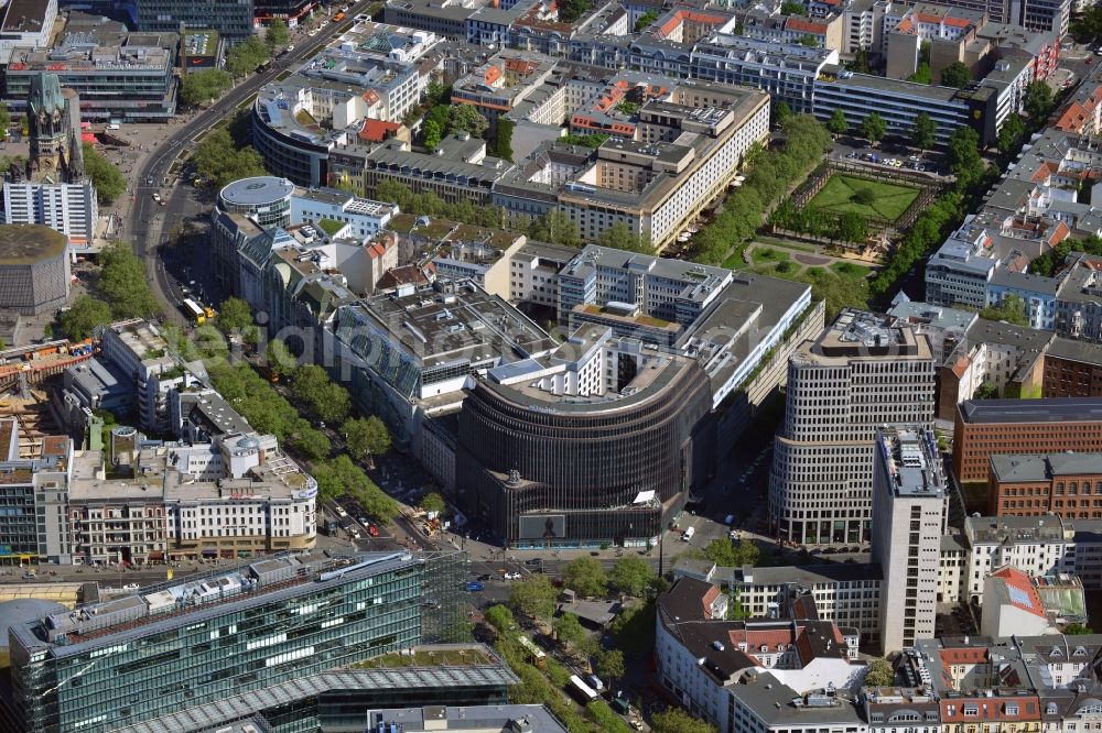 Aerial image Berlin - The Kudamm Corner is located at the corner of Kurfuerstendamm - Joachimstalerstrasse - Augsburger Strasse in Charlottenburg district of Berlin. The monumental building was designed by architects Gerkan, Marg and Partners and now houses a textile department store C & A and Swissôtel hotel. The shopping and service center is located in the City-West close to the Kaiser Wilhelm Memorial Church and the Neues Kranzler Eck. In the background, the Los Angeles-Platz is seen