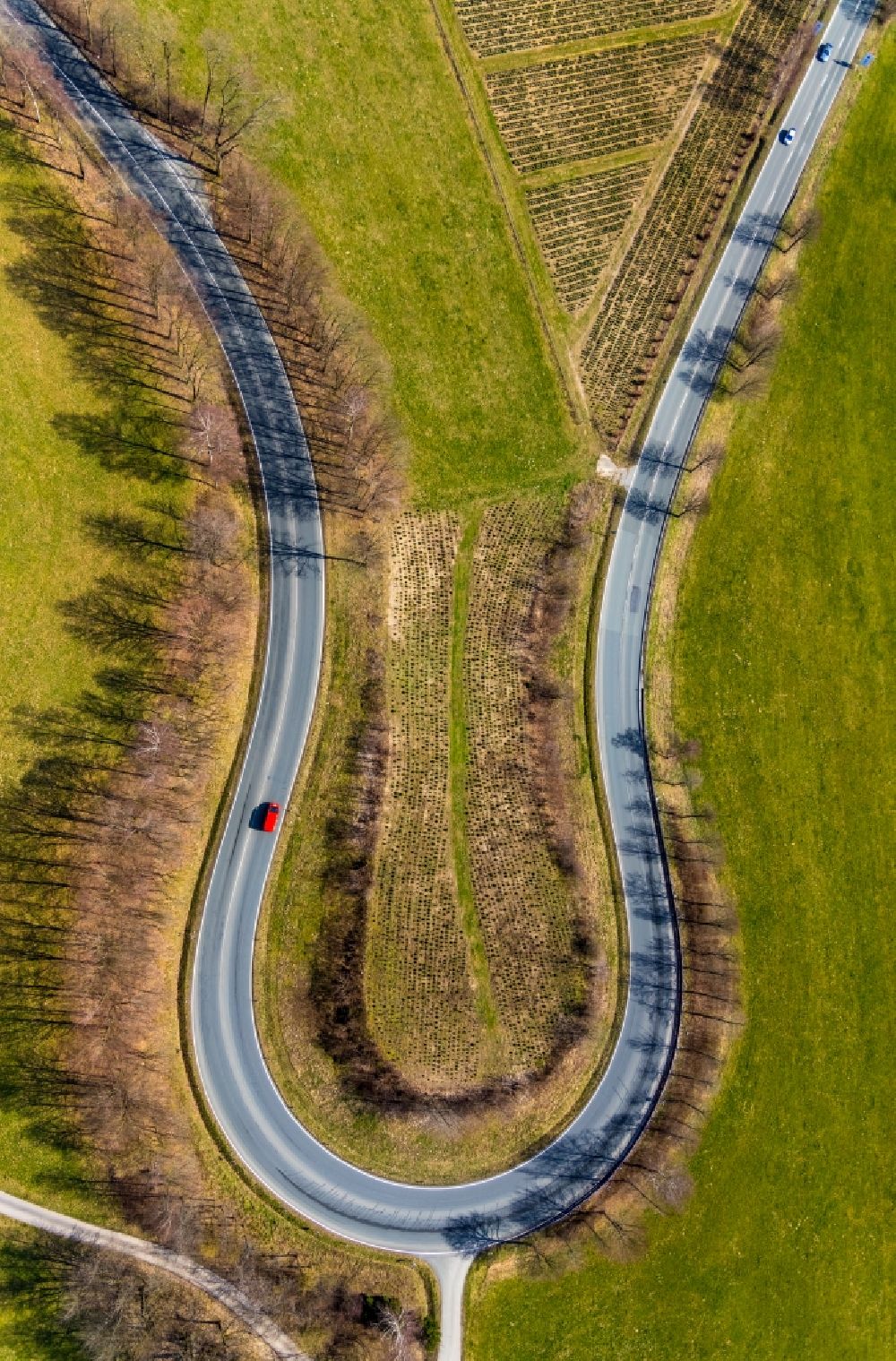 Olsberg from above - A serpentine curve of a road layout north of Olsberg in the state of North Rhine-Westphalia, Germany