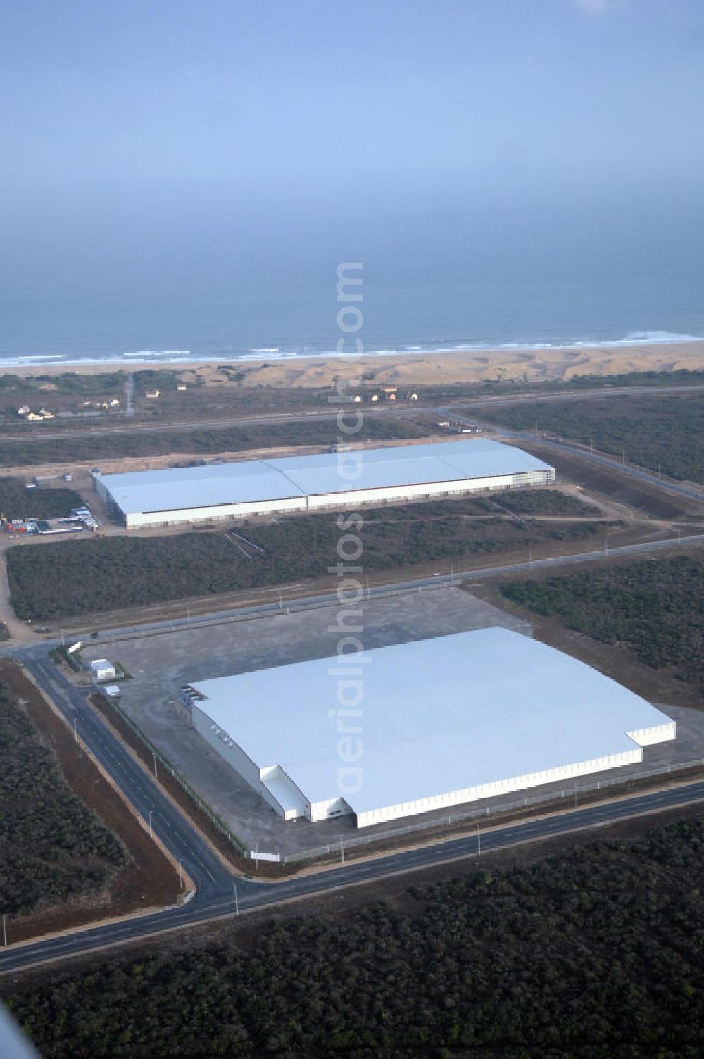 Aerial image PORT ELIZABETH - Warehouse of P E Cold Storage Ltd. in the industrial area at the coast of Port Elizabeth, South Africa. The region's industrial landscape is especially dominated by several weaving mills and the car industry