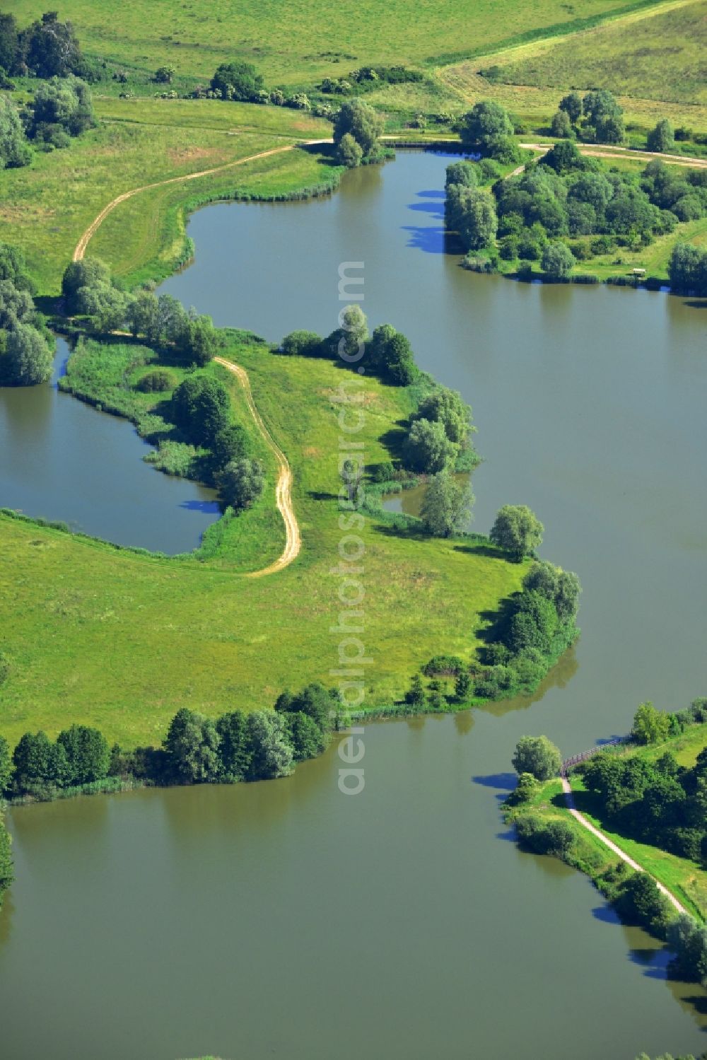 Aerial image Oberkrämer - View of the Mühlen lake in the local district Vehlefanz of the municipality Oberkrämer in Brandenburg. The lake was created by the LPG to be used as a water reservoir to irrigate the surrounding fields. To this day, the lake is still used for that
