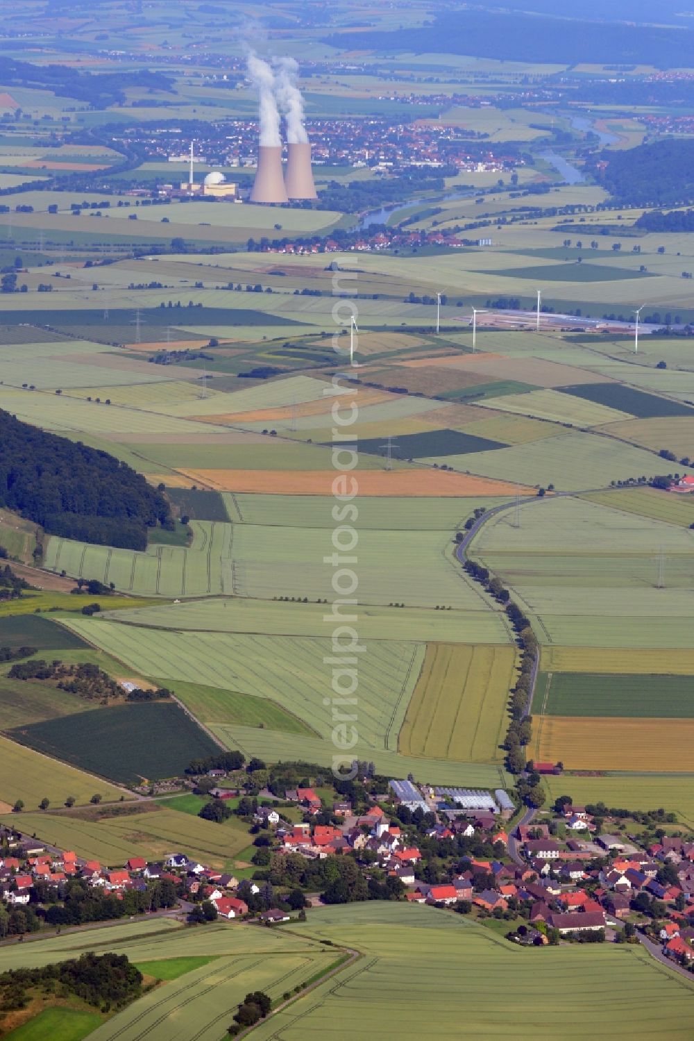 Heyen / Grohnde from the bird's eye view: Landscape view of the Weser Valley. In the foreground is the town of Heyen, in the background is the Nuclear power plant Grohnde in the state of Lower Saxony. The plant has a pressurized water reactor and is located at the river Weser in the county district of Hameln - Pyrmont. The here produced power is fed into the high-voltage network