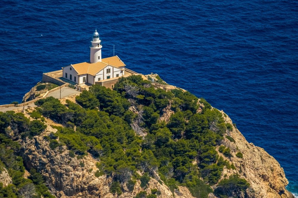 Aerial image Capdepera - Lighthouse as a historic seafaring character in the coastal area Faro de Capdepera on Carrer de sa Comassa in Capdepera in Balearic island of Mallorca, Spain