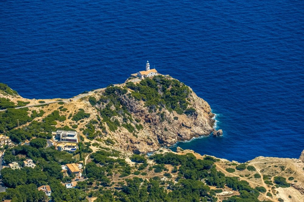 Aerial photograph Capdepera - Lighthouse as a historic seafaring character in the coastal area Faro de Capdepera on Carrer de sa Comassa in Capdepera in Balearic island of Mallorca, Spain