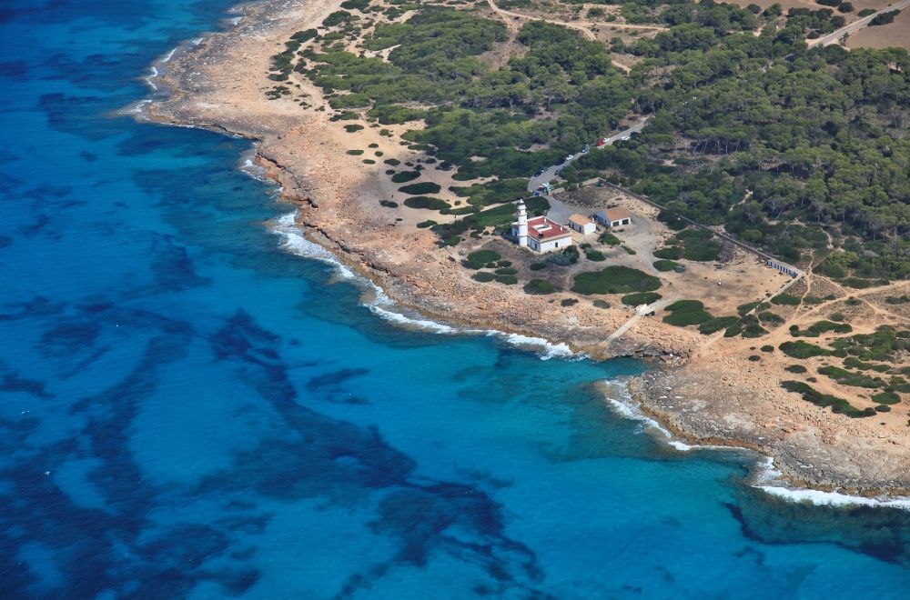 Cap de ses Salines from the bird's eye view: Lighthouse as a historic seafaring character in the coastal area of the Mediterranean Sea at the Cap de ses Salines at Mallorca in Balearic Islands, Spain