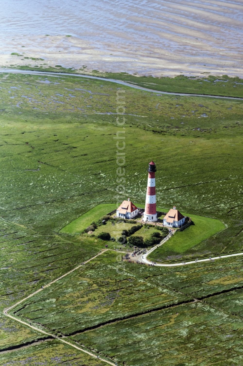 Westerhever from above - Lighthouse as a historic seafaring character in the coastal area of North Sea in the district Hauert in Westerhever in the state Schleswig-Holstein
