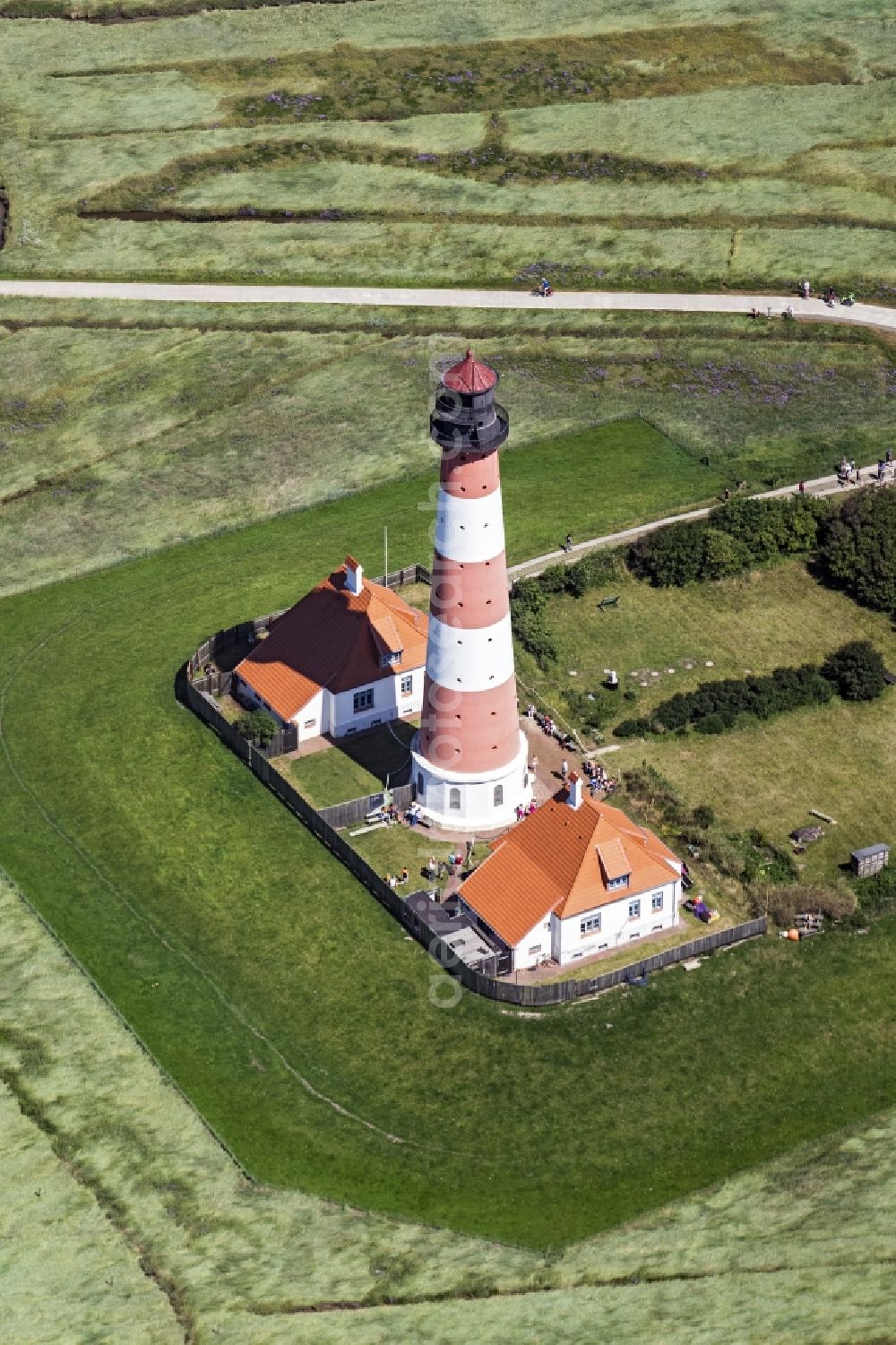 Westerhever from the bird's eye view: Lighthouse as a historic seafaring character in the coastal area of North Sea in the district Hauert in Westerhever in the state Schleswig-Holstein