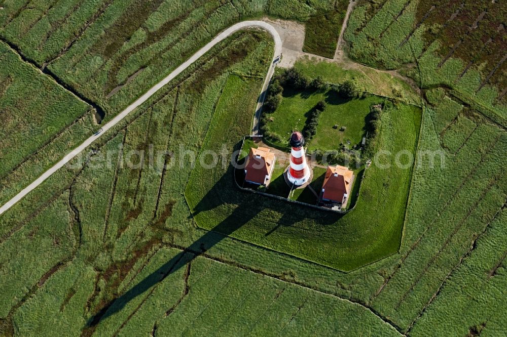 Tating from above - Lighthouse as a historic seafaring character in the coastal area of North Sea in the district Hauert in Westerhever in the state Schleswig-Holstein