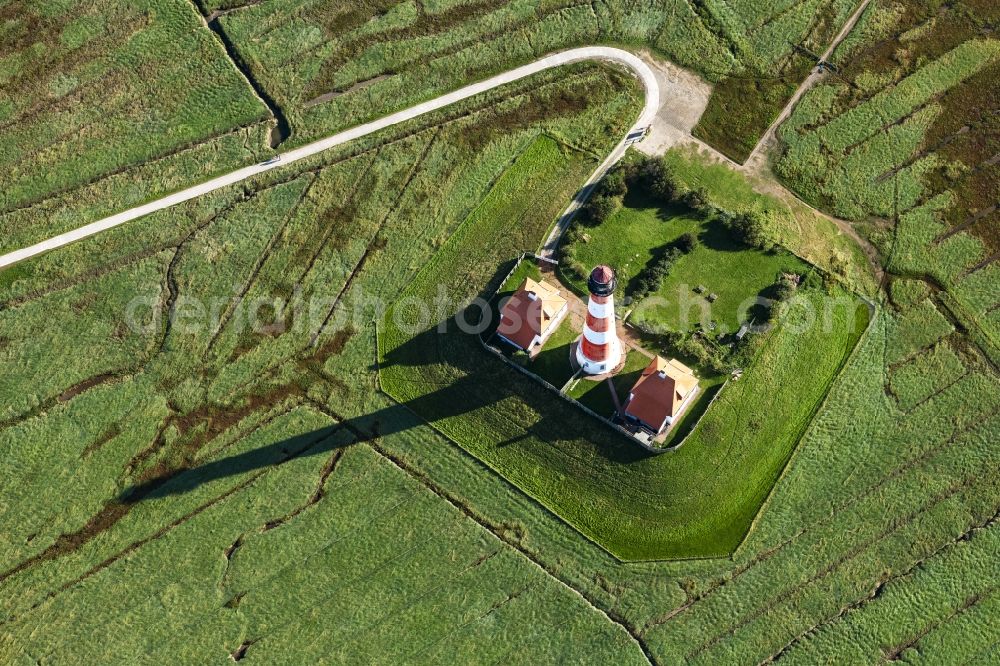 Tating from the bird's eye view: Lighthouse as a historic seafaring character in the coastal area of North Sea in the district Hauert in Westerhever in the state Schleswig-Holstein