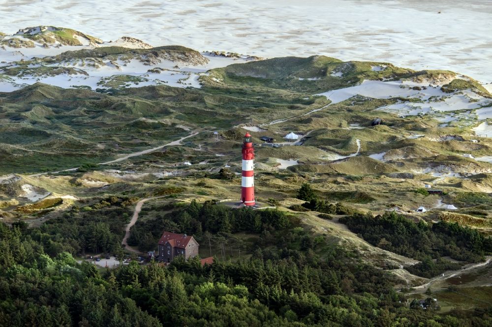 Nebel from above - Lighthouse as a historic seafaring character in the coastal area of the North Sea in Wittduen auf Amrum in the state Schleswig-Holstein