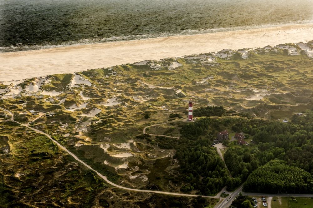 Nebel from above - Lighthouse as a historic seafaring character in the coastal area of the North Sea in Wittduen auf Amrum in the state Schleswig-Holstein