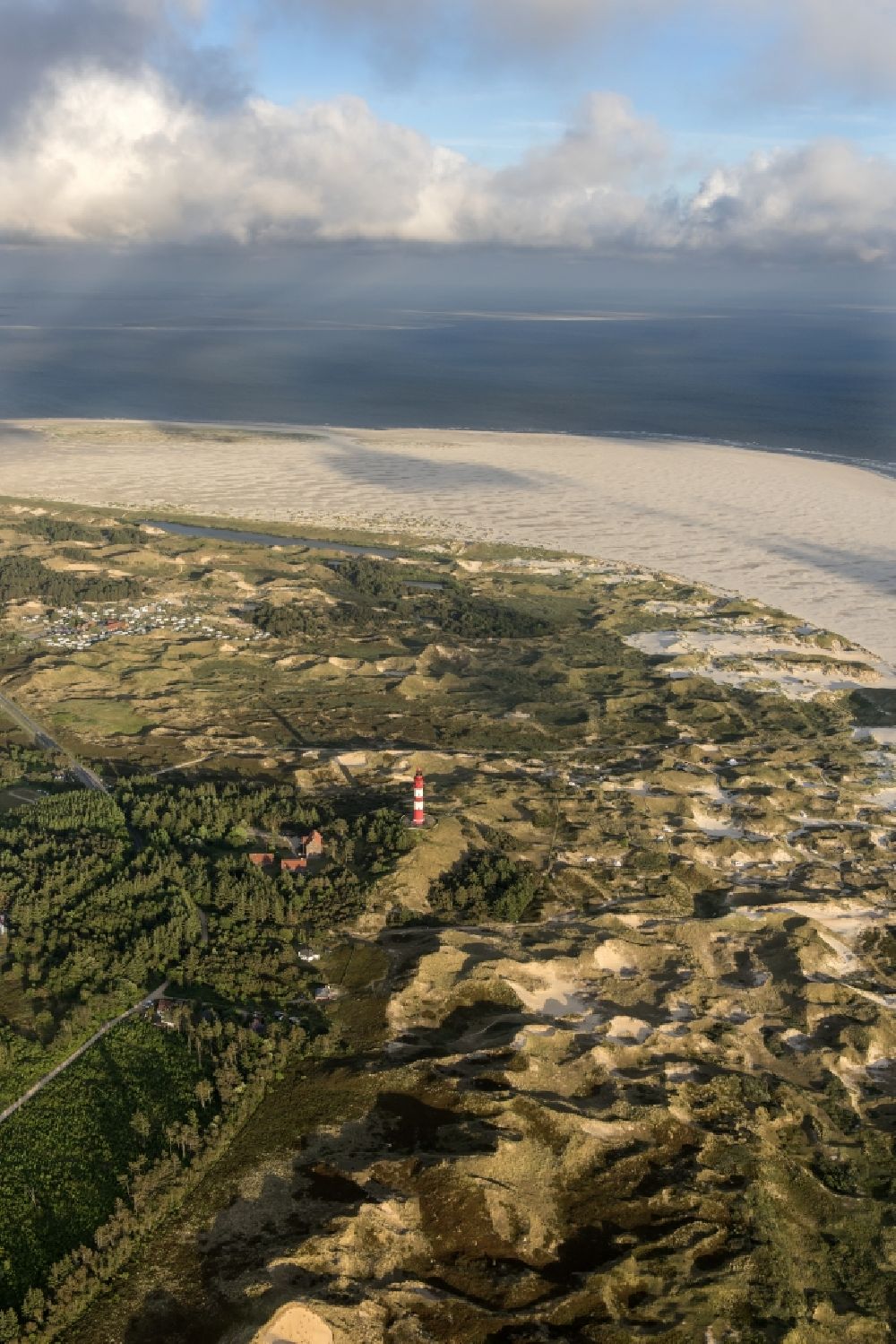 Aerial photograph Nebel - Lighthouse as a historic seafaring character in the coastal area of the North Sea in Wittduen auf Amrum in the state Schleswig-Holstein