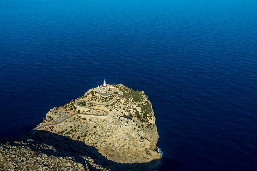 Aerial image Pollenca - Lighthouse as a historic seafaring character in the coastal area in Pollenca in Balearische Insel Mallorca, Spain