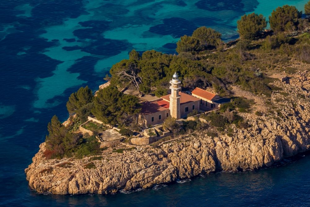 Aerial image Pollenca - Lighthouse of the Faro de Punta de la Avanzada as a historic seafaring character in the coastal area in Pollenca in Balearische Insel Mallorca, Spain