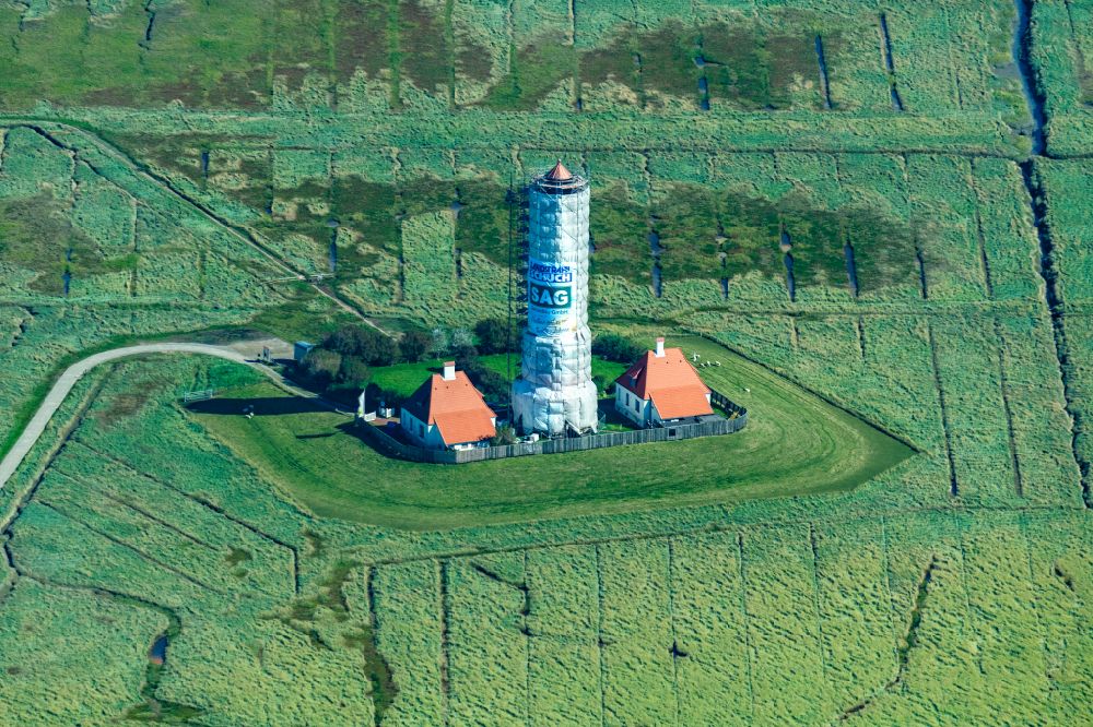 Aerial photograph Westerhever - Sandblasting and renovation work on the Westerheversand lighthouse as a historical maritime symbol in the coastal area of the North Sea in Westerhever in the state of Schleswig-Holstein