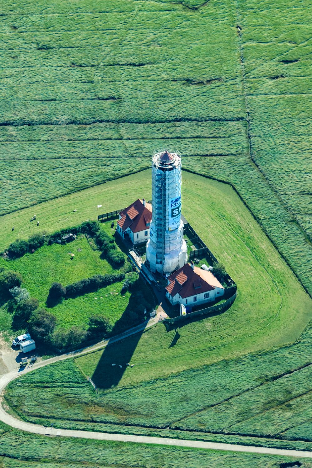 Westerhever from the bird's eye view: Sandblasting and renovation work on the Westerheversand lighthouse as a historical maritime symbol in the coastal area of the North Sea in Westerhever in the state of Schleswig-Holstein