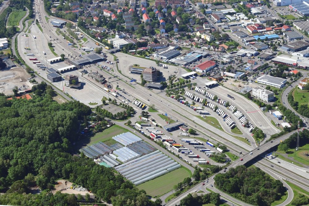Weil am Rhein from the bird's eye view: Lorries - parking spaces at the highway rest stop and parking of the BAB A5 at the border crossing Germany - Switzerland in Weil am Rhein in the state Baden-Wurttemberg, Germany