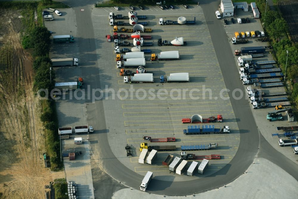 Aerial photograph Aurich - Lorries freight loaded with components of a wind turbine on the ground of ENERCON GmbH in Aurich in the state Lower Saxony