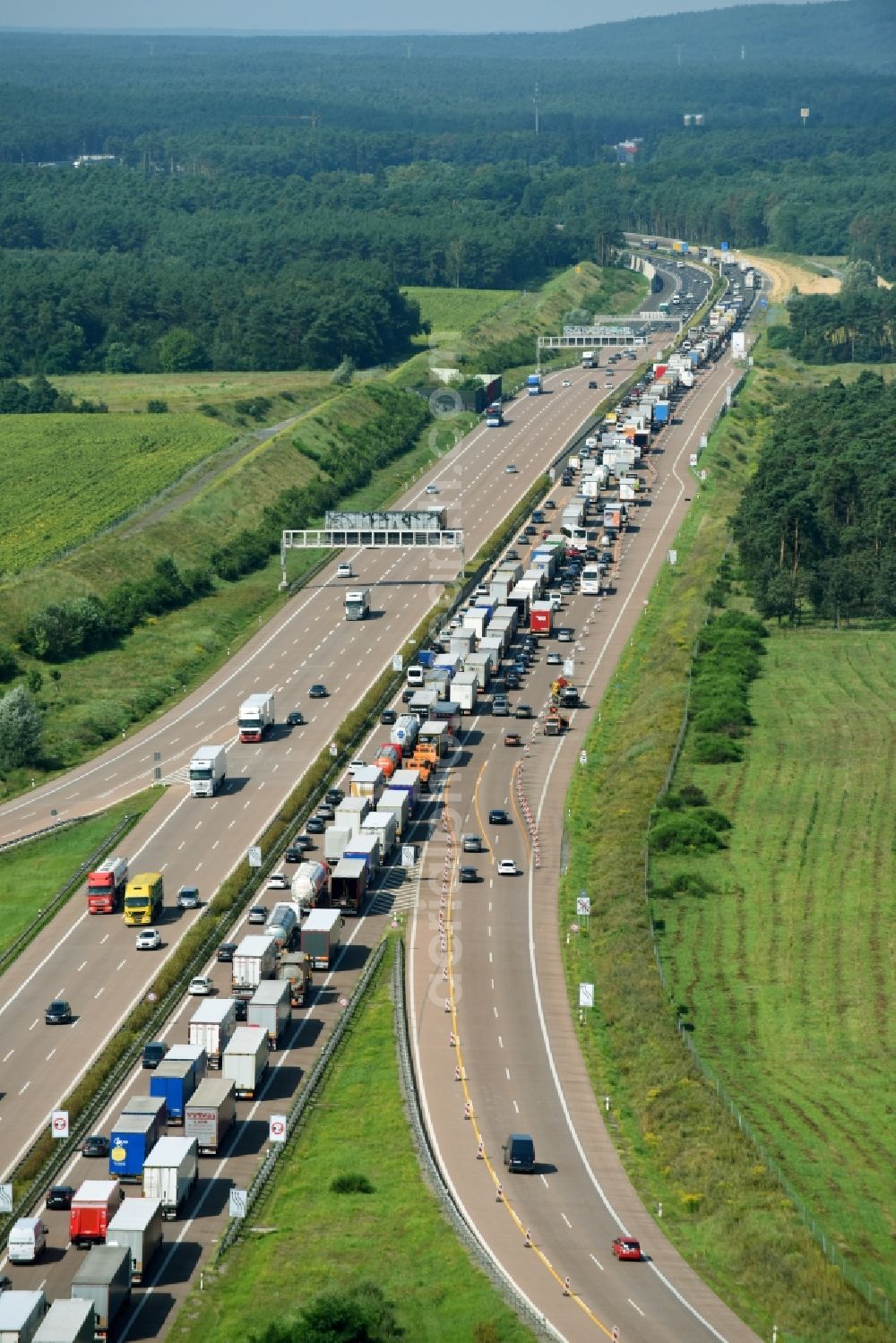 Michendorf from the bird's eye view: Lorries freight by road along the federal highway and motorway A10 in Michendorf in the state Brandenburg, Germany