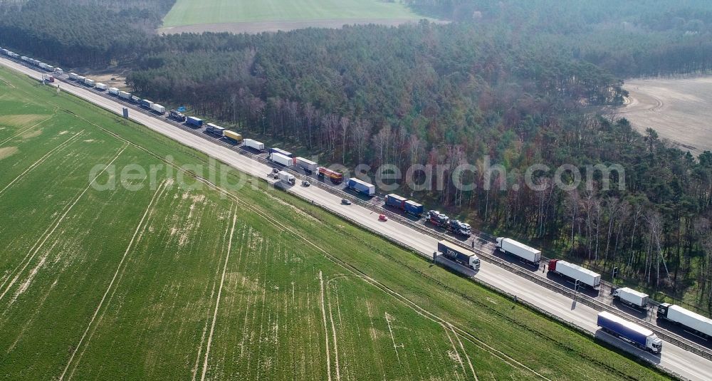 Güldendorf from the bird's eye view: Lorries crowded in traffic jams in the lanes of the route of the motorway BAB A12 in Gueldendorf in the state Brandenburg, Germany