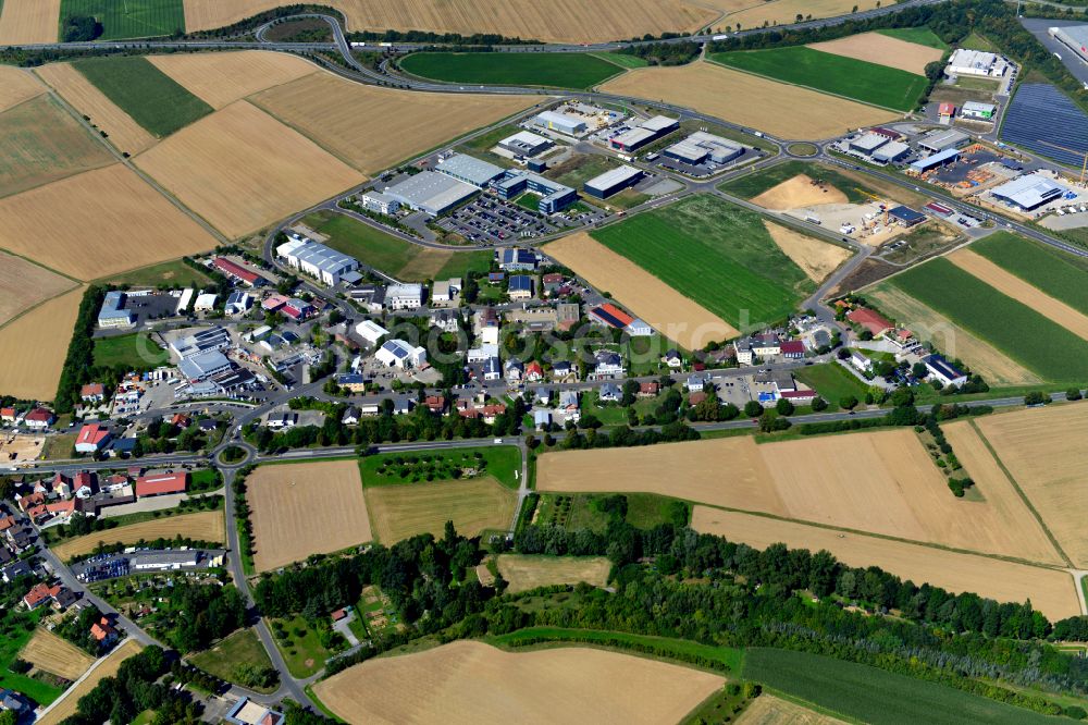 Aerial photograph Estenfeld - Industrial and commercial area on the edge of agricultural fields and fields in Estenfeld in the state Bavaria, Germany