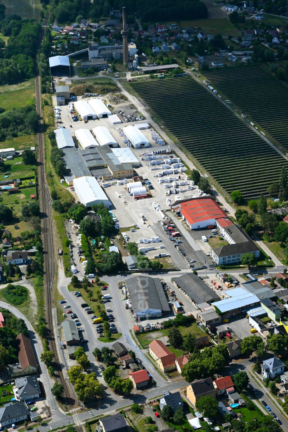 Aerial photograph Klosterfelde - Industrial and commercial area on the edge of agricultural fields and fields on street Beusterstrasse in Klosterfelde in the state Brandenburg, Germany