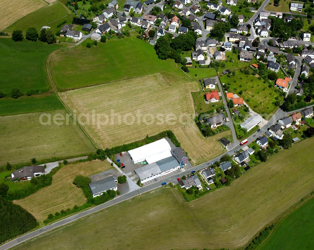 Aerial photograph Lippertsgrün - Industrial and commercial area on the edge of agricultural fields and fields in Lippertsgrün in the state Bavaria, Germany