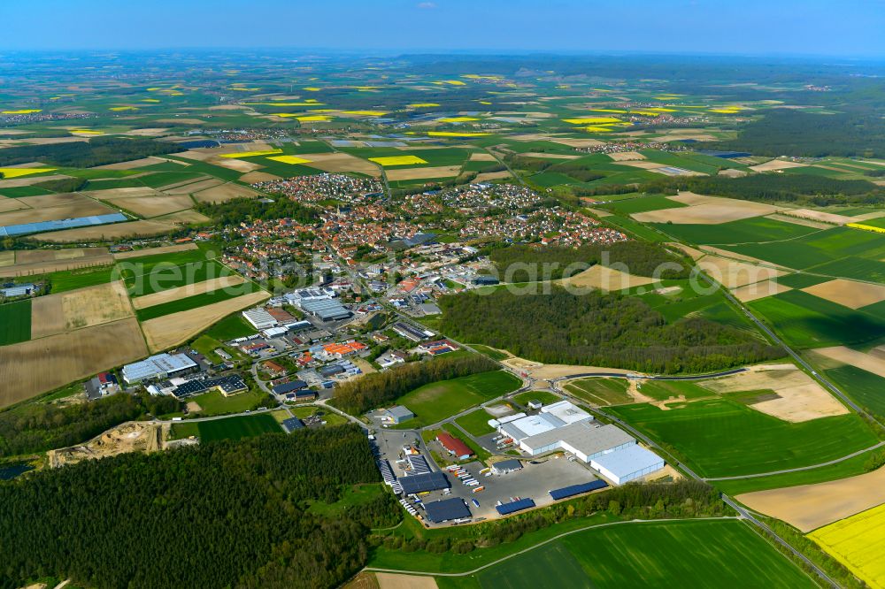 Aerial photograph Wiesentheid - Industrial and commercial area on the edge of agricultural fields and fields on street Industriestrasse in Wiesentheid in the state Bavaria, Germany