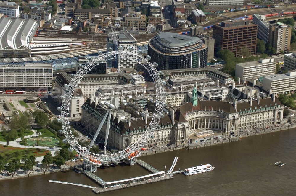 Aerial photograph London - View the London Eye, also known as Millennium Wheel - a landmark of London. The current tallest Ferris wheel in Europe is the main attraction for tourists from around the world on the banks of the Thames Millennium Pier in front of the building of the London Sea Life Aquarium and Park Gardens Jubiles