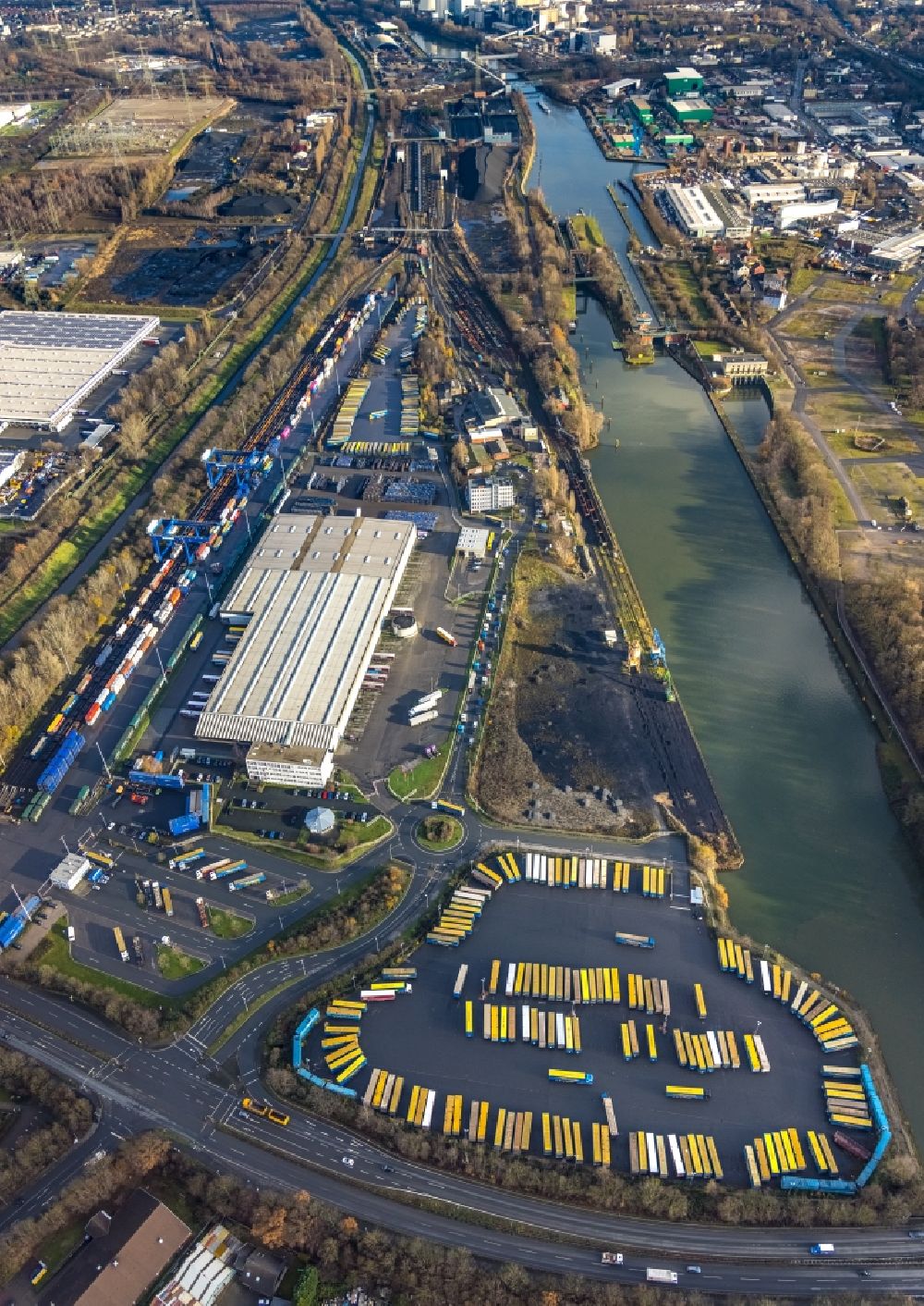 Herne from the bird's eye view: Aerial view of truck parking areas and open-air warehouse of Mueller - Die lila Logistik GmbH & Co. KG Am Westhafen and Wanne-Herner Eisenbahn und Hafen GmbH on the Rhine-Herne Canal in Herne in the federal state of North Rhine-Westphalia, Germany