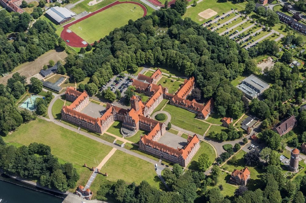 Aerial photograph Flensburg - The Naval School Muerwik, abbreviation MSM, is the training center for officers and officer candidates of the navy with its subordinate sailing training ship Gorch Fock. In the district of Flensburg-Muerwik, the foundation stone was laid in 1907 for the building erected according to the generous plans of the Naval Building Authority Kelm. The external design of the MSM, which is also called the Red Castle on the sea, is very similar to the historic buildings of the East Prussian Marienburg of the Teutonic Knights