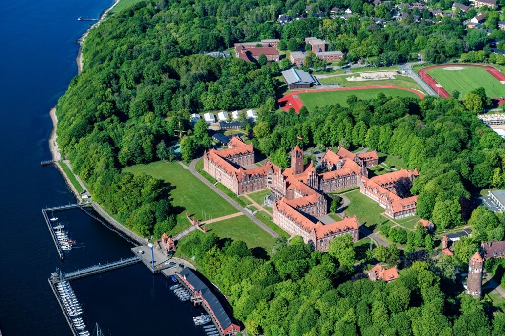 Flensburg from the bird's eye view: The Naval School Muerwik, abbreviation MSM, is the training center for officers and officer candidates of the navy with its subordinate sailing training ship Gorch Fock. In the district of Flensburg-Muerwik, the foundation stone was laid in 1907 for the building erected according to the generous plans of the Naval Building Authority Kelm. The external design of the MSM, which is also called the Red Castle on the sea, is very similar to the historic buildings of the East Prussian Marienburg of the Teutonic Knights