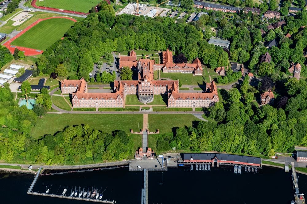 Aerial photograph Flensburg - The Naval School Muerwik, abbreviation MSM, is the training center for officers and officer candidates of the navy with its subordinate sailing training ship Gorch Fock. In the district of Flensburg-Muerwik, the foundation stone was laid in 1907 for the building erected according to the generous plans of the Naval Building Authority Kelm. The external design of the MSM, which is also called the Red Castle on the sea, is very similar to the historic buildings of the East Prussian Marienburg of the Teutonic Knights