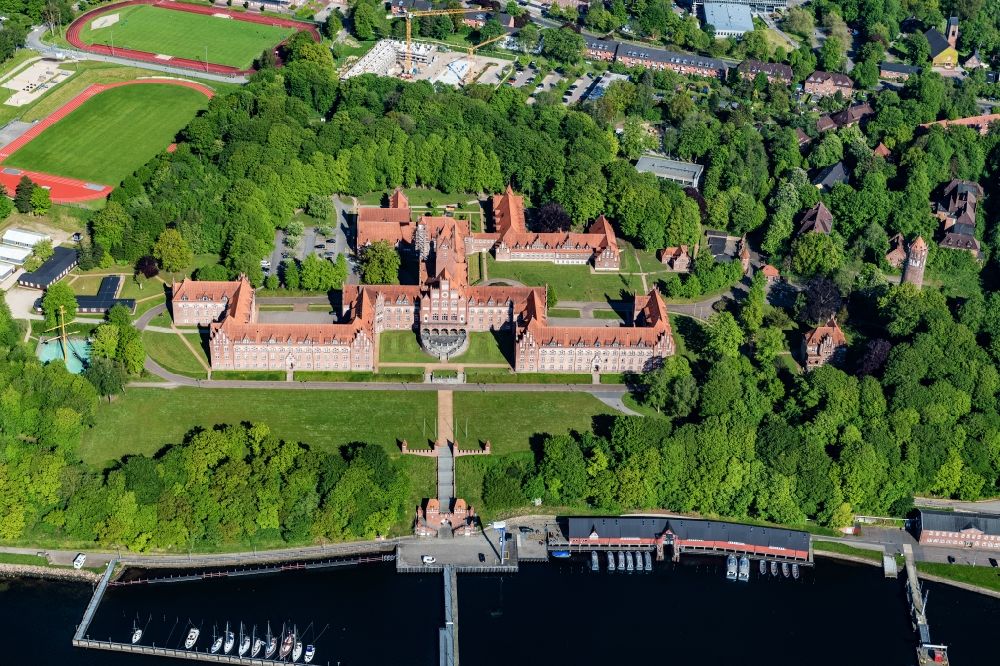 Flensburg from above - The Naval School Muerwik, abbreviation MSM, is the training center for officers and officer candidates of the navy with its subordinate sailing training ship Gorch Fock. In the district of Flensburg-Muerwik, the foundation stone was laid in 1907 for the building erected according to the generous plans of the Naval Building Authority Kelm. The external design of the MSM, which is also called the Red Castle on the sea, is very similar to the historic buildings of the East Prussian Marienburg of the Teutonic Knights