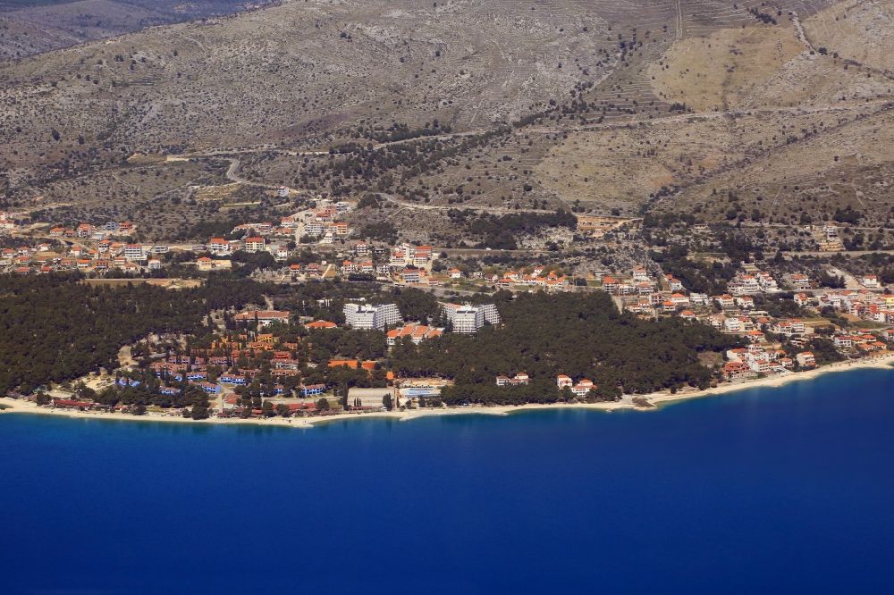 Aerial image Seget Donji - Townscape on the seacoast of Adriatic Sea in Seget Donji in Splitsko-dalmatinska zupanija, Croatia