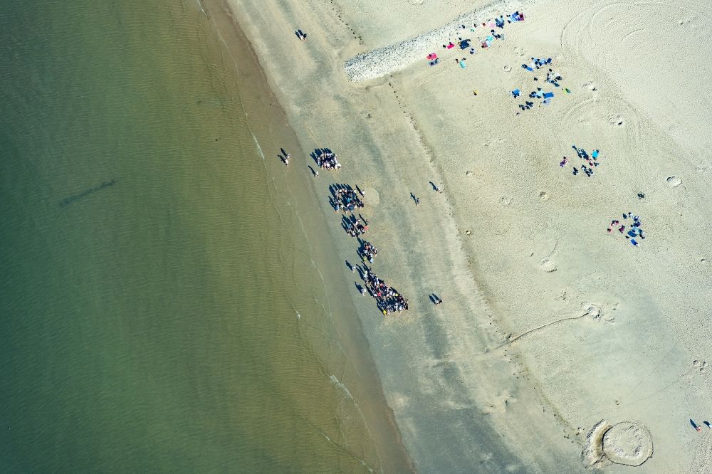 Borkum from the bird's eye view: People group on the sandy beach in the coastal area of a??a??the North Sea in Borkum in the state Lower Saxony