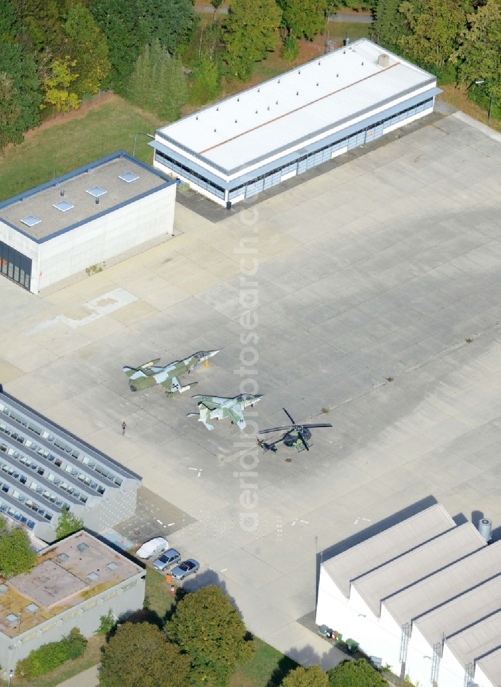 Unterhaching from above - Military airplanes and helicopter on site of the University of the Bundeswehr Munich in Unterhaching in the state of Bavaria. The two jets and the helicopter are located in front of hangars and outbuildings