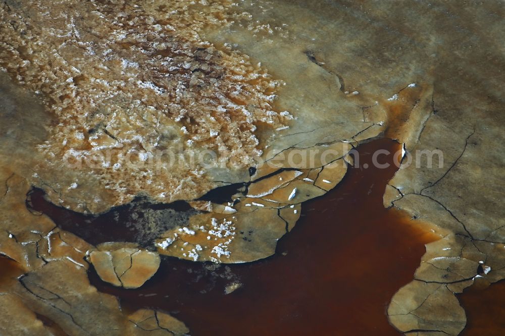 Aerial photograph Bad Buchau - View of the Federsee which is partly covered with ice in Bad Buchau in the state Baden-Wuerttemberg. The lake is located in the Swabian Alb, the ice is broken and the water is coloured because of minerals