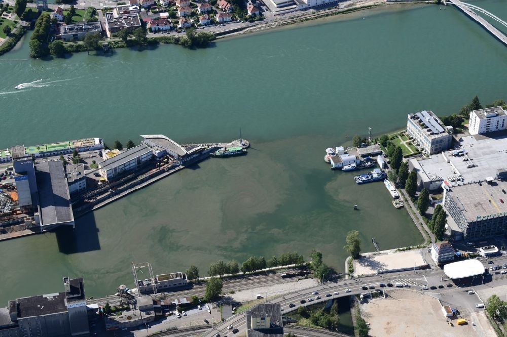 Basel from the bird's eye view: In the middle of the river Rhine the three countries Germany, Switzerland and France merge in Basel in Switzerland. A Pylon is symbolising the location in the harbor area of Basle in Switzerland