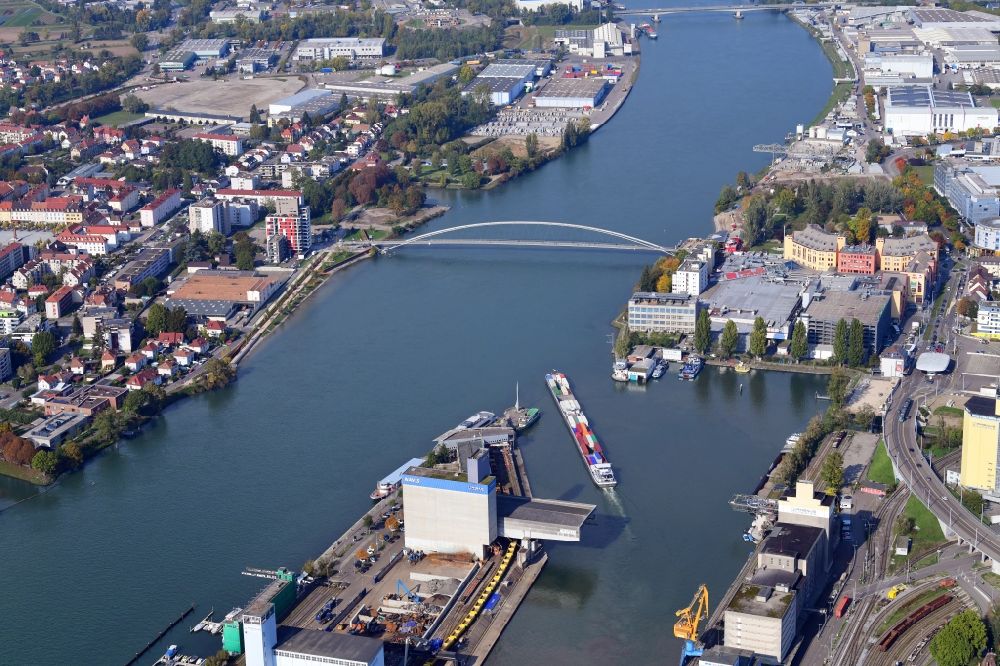 Basel from above - In the middle of the river Rhine the three countries Germany, Switzerland and France merge in Basel in Switzerland. A Pylon is symbolising the location in the harbor area of Basle in Switzerland