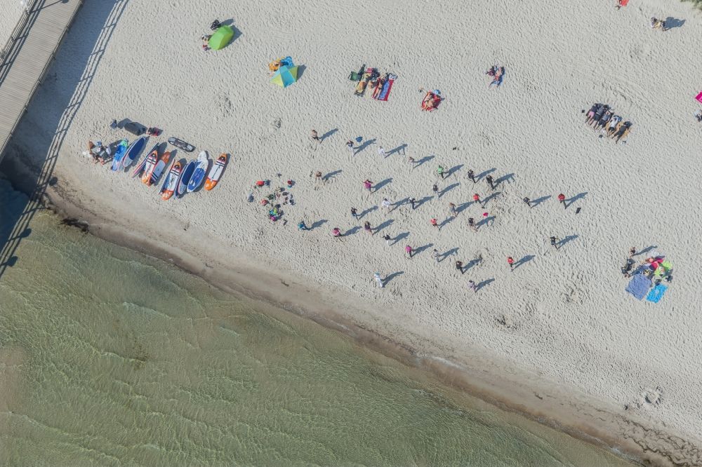 Aerial image Scharbeutz - Morning gymnastics Strandkorb- rows on the sandy beach in the coastal area of a??a??the Baltic Sea in Scharbeutz in the state of Schleswig-Holstein