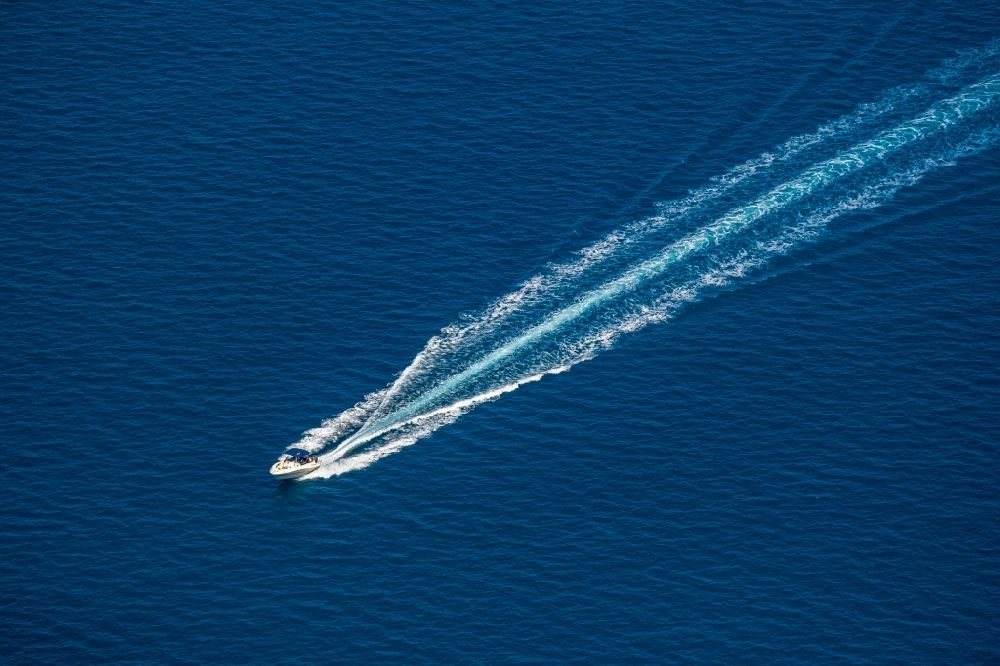 Aerial image Alcudia - Motorboat - speedboat in motion in the bay of Alcudia in Alcudia in Balearic island of Mallorca, Spain