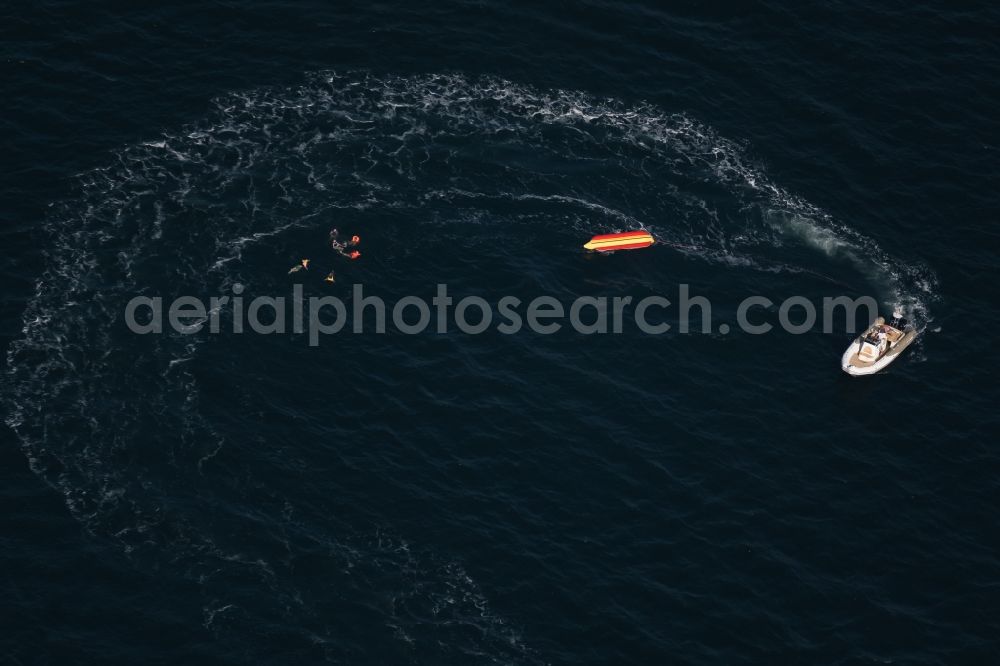 Aerial photograph Pelzerhaken - Motorboat - Speedboat driving with a overturned banana boat in tow on the Baltic Sea near Pelzerhaken in the state Schleswig-Holstein, Germany
